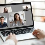 Three People Displayed on Video Call over Laptop While Woman Looks