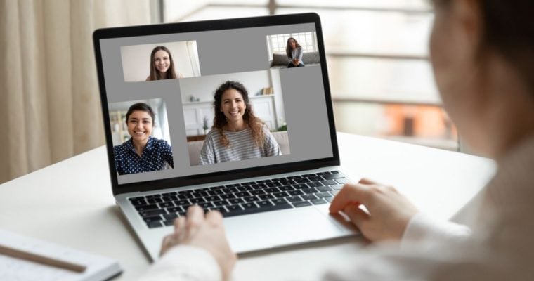 Three People Displayed on Video Call over Laptop While Woman Looks