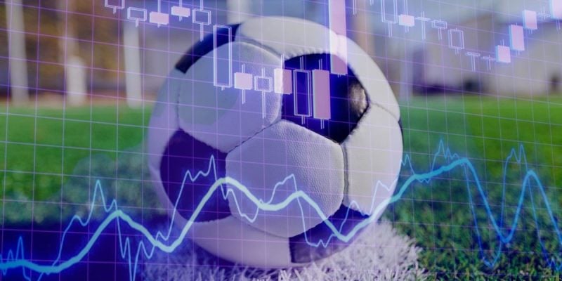 Blue Financial Line Graph Overlays Image of Soccer Ball on Green Grass
