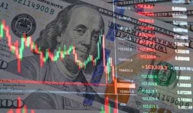 $100 Bills of US Currency with Overlay Image of Financial Graph Fluctuations