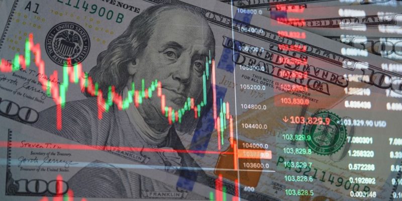 $100 Bills of US Currency with Overlay Image of Financial Graph Fluctuations