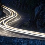 Long Exposure Of White Car Lights On Curving Road in NY