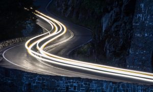 Long Exposure Of White Car Lights On Curving Road in NY