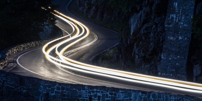 Long Exposure Of White Car Lights On Curving Road in NY