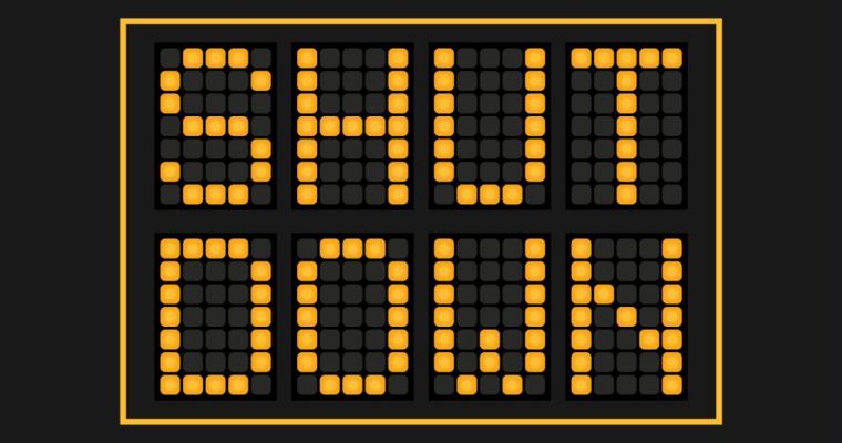 Road Sign Reads Shut Down in Yellow L.E.D. Lights on Black Background