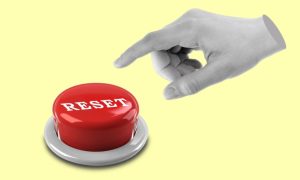 Isolated Hand Points To Red Reset Button on Yellow Background