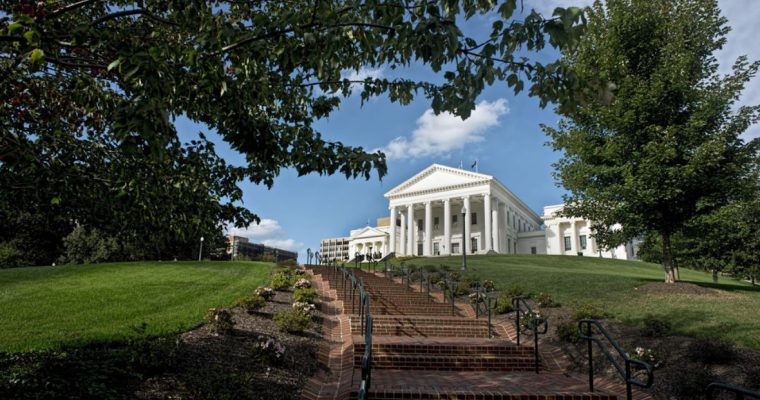 Blue Skies and Green-Leafed Trees Surround a While Capitol Building in VA