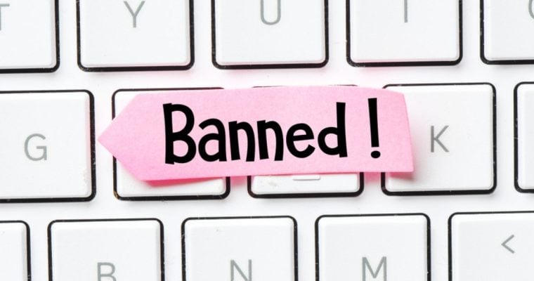 Pink Paper Reads Banned! Sitting On Top of White Keyboard