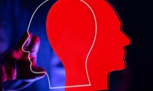 One Red and One Transparent Head Facing Opposite Directions Overlap with Man Touching