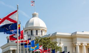 The Top of the Alabama State Capitol Building and Various State Flags Flying