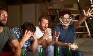 Men Watching American Football Display Varying Levels of Enthusiasm