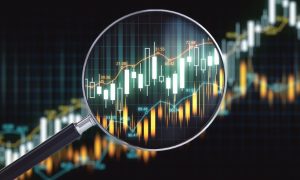 Financial Graph Tracks Up With Magnifying Glass Laying On Top