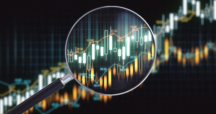 Financial Graph Tracks Up With Magnifying Glass Laying On Top