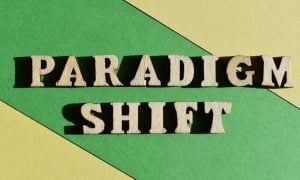 Blocked Yellow and Green Background to Wooden Blocks Reading Pardigm Shift