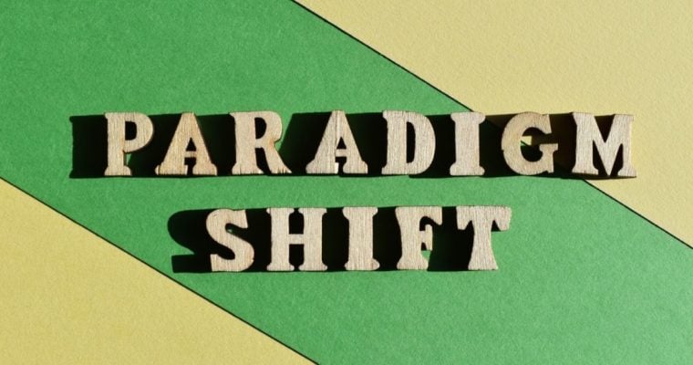 Blocked Yellow and Green Background to Wooden Blocks Reading Pardigm Shift
