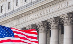 Close Up of Building Text Reading United States Court House with American Flag In Front