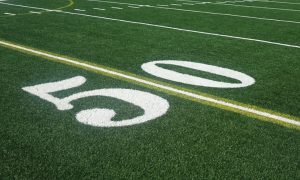 Close Up of the 50-Yard Line on a Green Grass American Football Field