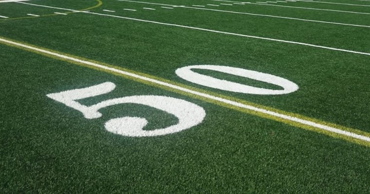 Close Up of the 50-Yard Line on a Green Grass American Football Field