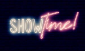 Neon Light Reads Show Time! In White and Pink Font