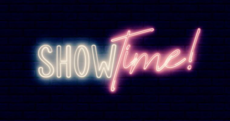 Neon Light Reads Show Time! In White and Pink Font