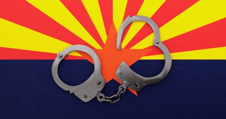 Steel Handcuffs Sit On Top of Arizona State Flag