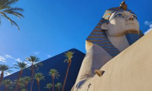 Las Vegas' Luxor Hotel with Black Pyramid and Sphinx Against Blue Sky