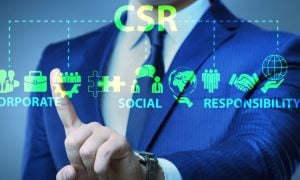 Man in Blue Suit Touches Screen With Digital Overlay of Corporate Social Responsibility (CSR) Icons