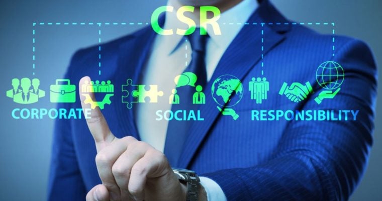 Man in Blue Suit Touches Screen With Digital Overlay of Corporate Social Responsibility (CSR) Icons