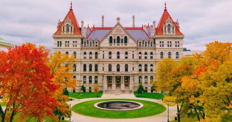 Aerial View on New York State Capitol Building Surrounded by Colorful Trees and Green Grass
