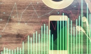 Bar Graph in Green Digital Image Overlay on Wood Desk with Laptop, Coffee and Cell Phone