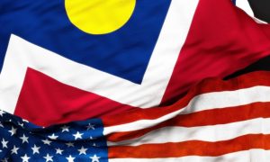Close Up of Colorado Flag Laying Above the American Flag