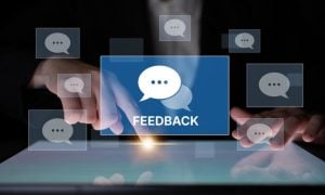 Man's Finger With Point of Light on Digital Screen and Pop Ups of Speech Bubbles with Word Feedback