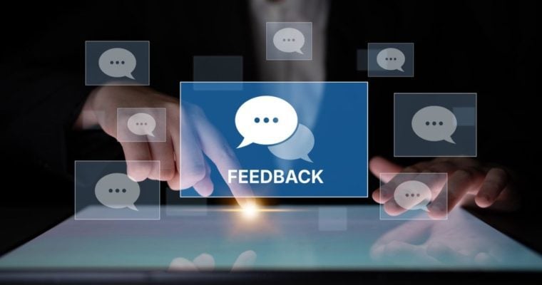 Man's Finger With Point of Light on Digital Screen and Pop Ups of Speech Bubbles with Word Feedback