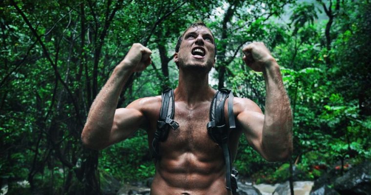 Shirtless Man In Wilderness Looks Up With Strong Arms