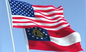 Georgia State Flag Waves Below US Flag with Blue Skies Background