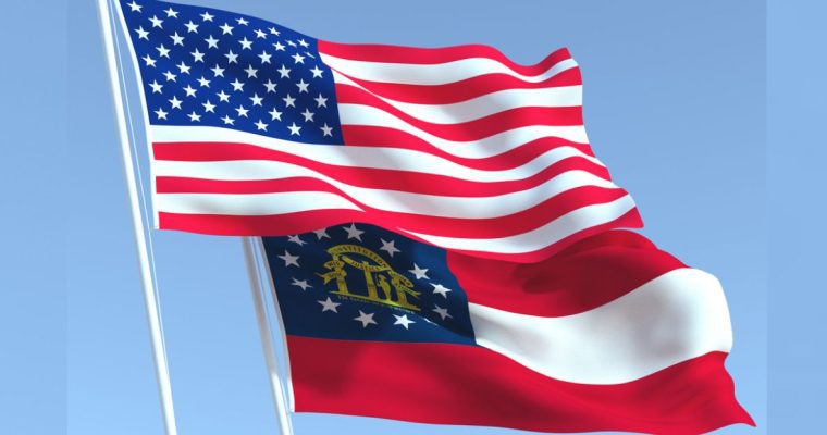 Georgia State Flag Waves Below US Flag with Blue Skies Background