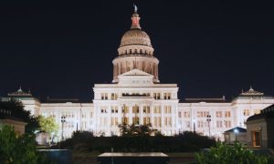 Bright White Lights Shine at Texas State Capitol Building in Stark Contrast to Black Skies
