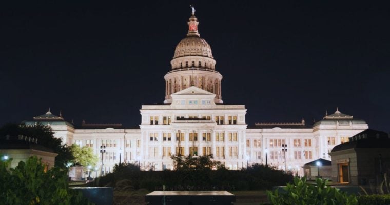 Bright White Lights Shine at Texas State Capitol Building in Stark Contrast to Black Skies