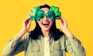 Woman Wears Oversized Four-Leaf-Clover Shaped Glasses on Yellow Background