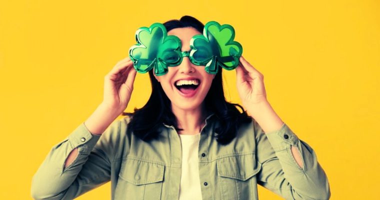 Woman Wears Oversized Four-Leaf-Clover Shaped Glasses on Yellow Background