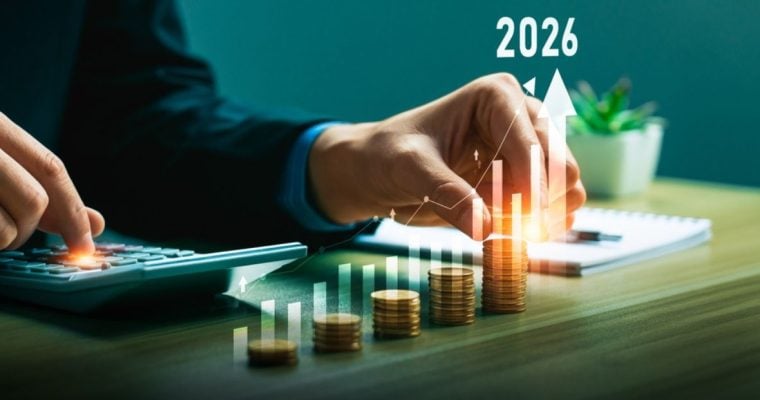 Man Sitting at Desk Uses Calculator to Count Stacked Coins with Digital Overlay of Bar Graph and 2026
