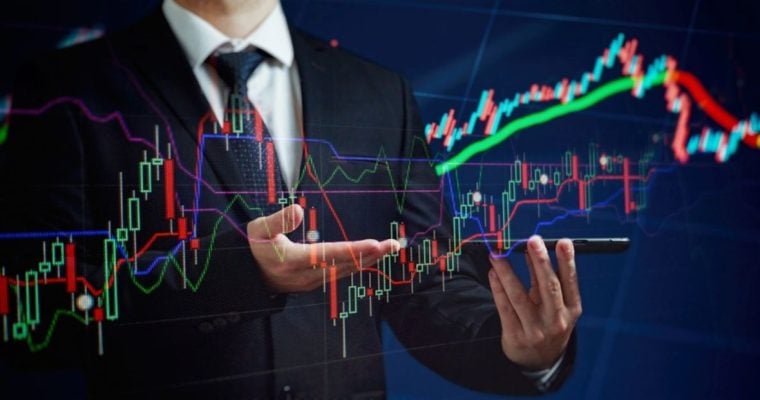 Colorful Financial Line Graphs Displayed Across Image of Man In A Suit Holding Smartphone