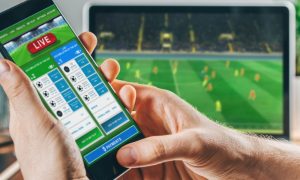Live Sports Betting App Displayed on Cell Phone Held By Man's Hands
