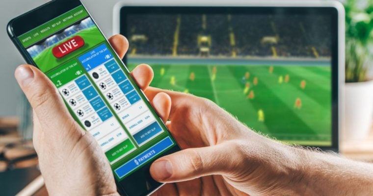 Live Sports Betting App Displayed on Cell Phone Held By Man's Hands