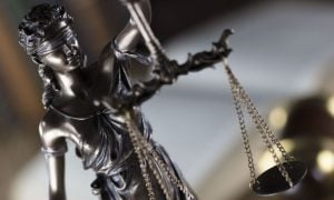 Bronze Statue of Lady Justice is Blindfolded and Holds the Scales