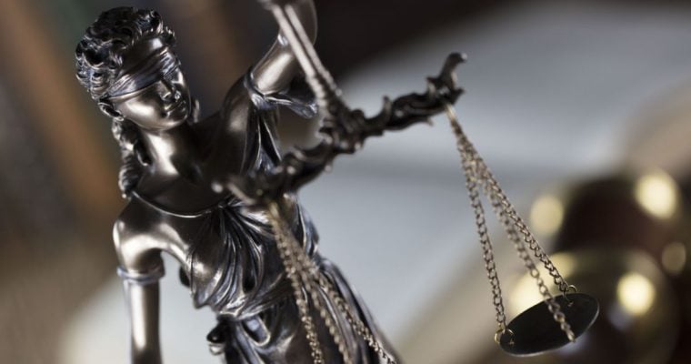 Bronze Statue of Lady Justice is Blindfolded and Holds the Scales