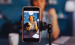 Young Woman as Online Influencer Records a Video Using Smartphone