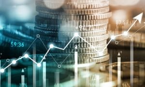Stacks of Silver Coins As Background to Digital Bar and Line Graphs