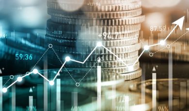 Stacks of Silver Coins As Background to Digital Bar and Line Graphs