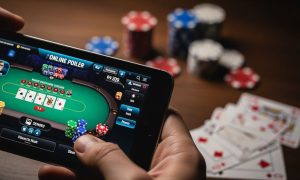 Online Poker Game Displayed on Mobile Device with Poker Chips and Playing Cards on Table
